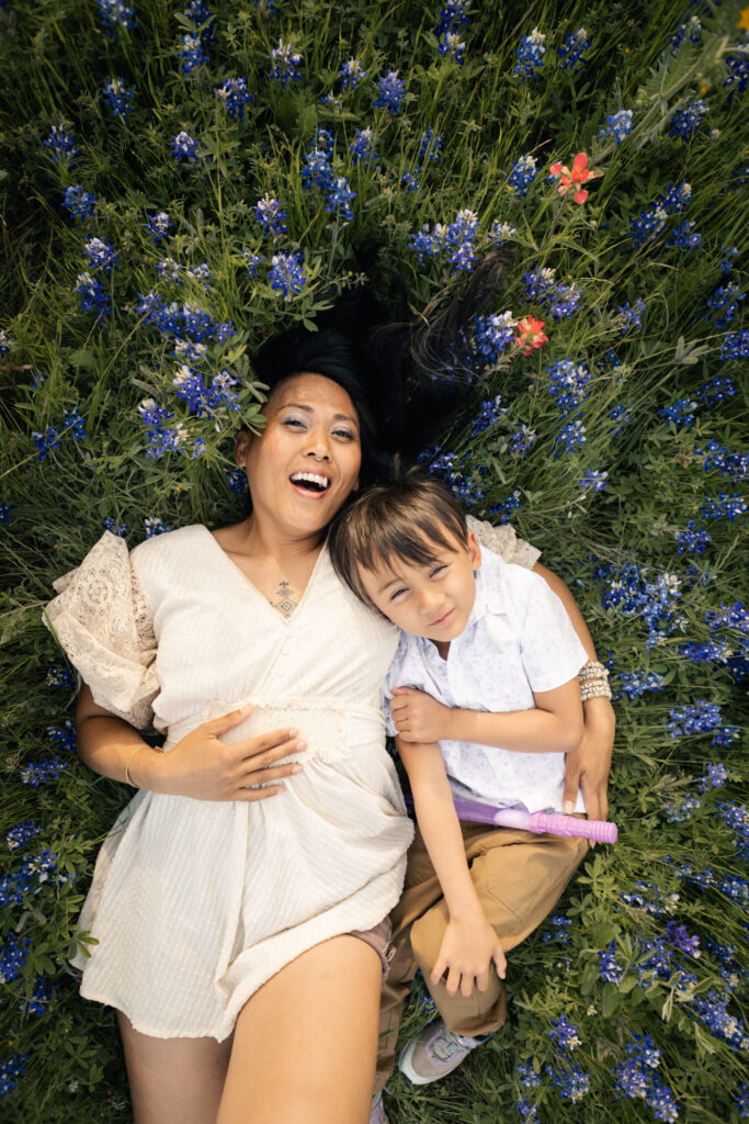 mother and son enjoying the Austin flower blooms at McKinney Falls State Park, captured by lifestyle family photographer