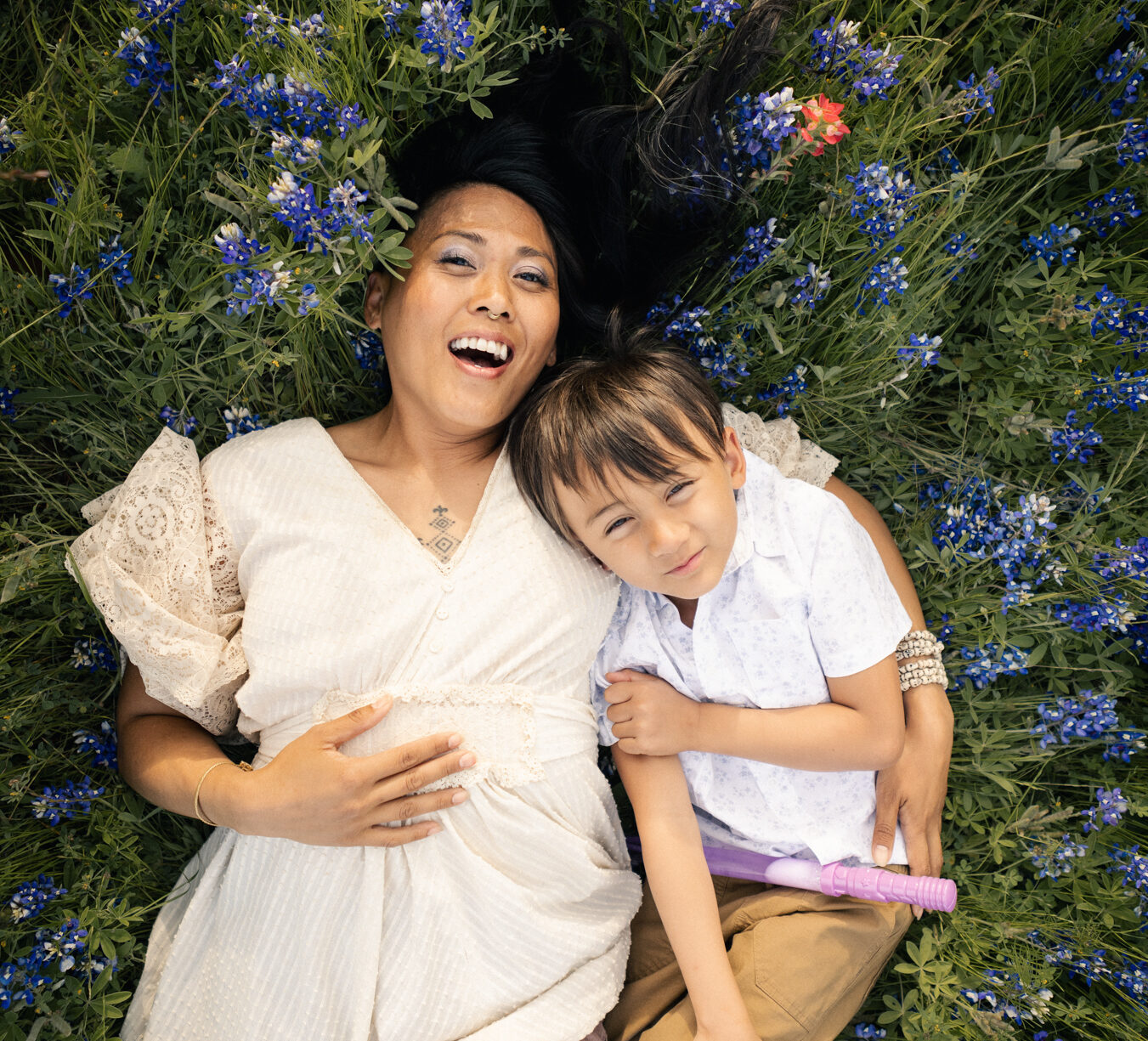 mother and son enjoying the Austin flower blooms at McKinney Falls State Park, captured by lifestyle family photographer